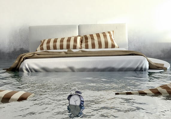 A sleeping room that suffered water damage during a flood that illustrates the importance of flood insurance