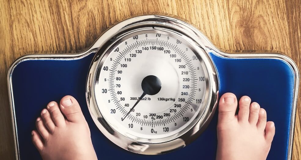 feet on scale measuring weight insurance for obese people