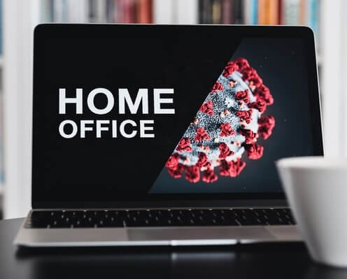 A laptop on a table that reads home office to illustrate how to work from home in the times of coronavirus.