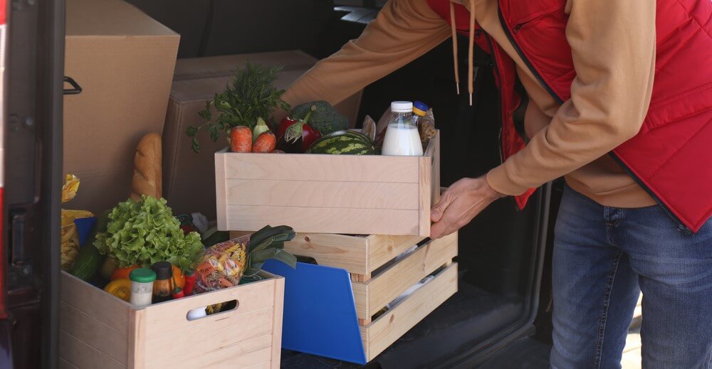 food delivery driver unloading groceries with car insurance