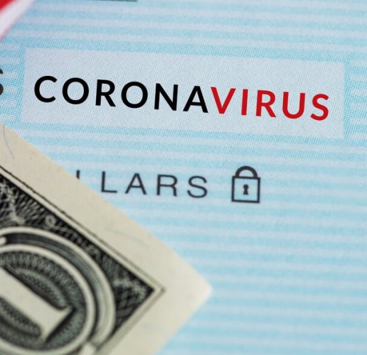 A dollar bill placed on a screen that reads Coronavirus to portray stimulus checks for the coronavirus.