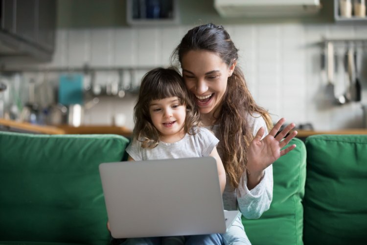 happy mother and daughter with laptop having a video call