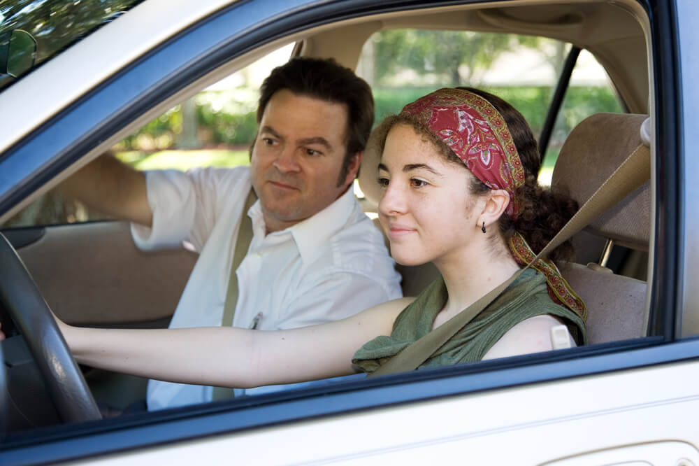 Teen learning to drive or taking driving test with cheap auto insurance