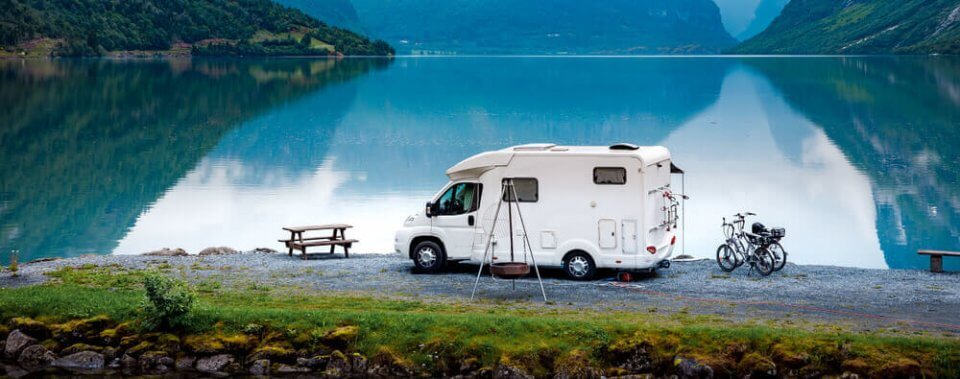 used camper parked by a lake