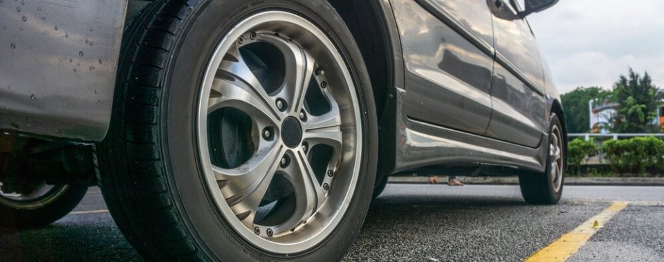 Close-up to a car tire to explain the numbers on the side to portray what is H or V rating on tires.