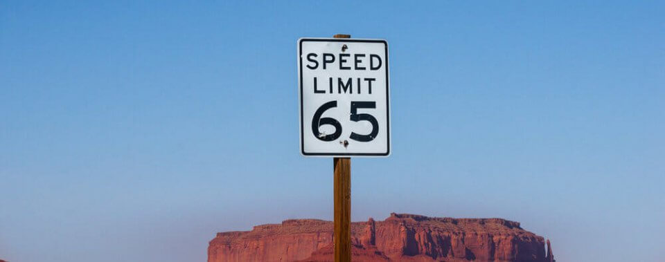 speed limit sign on road to avoid speeding tickets