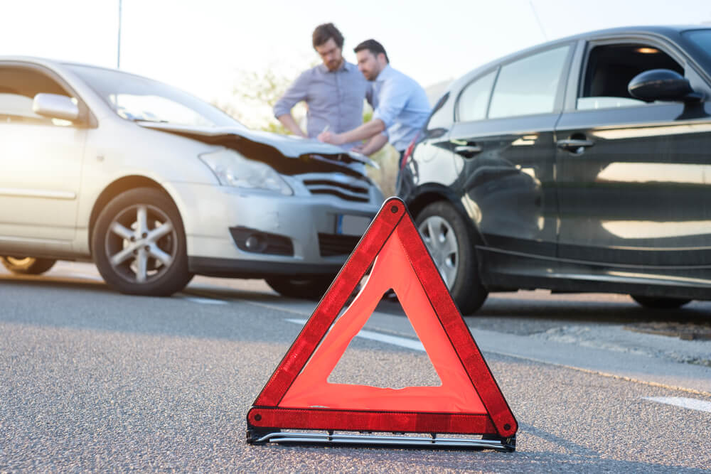 an emergency cone in front of a underinsured motorist car accident