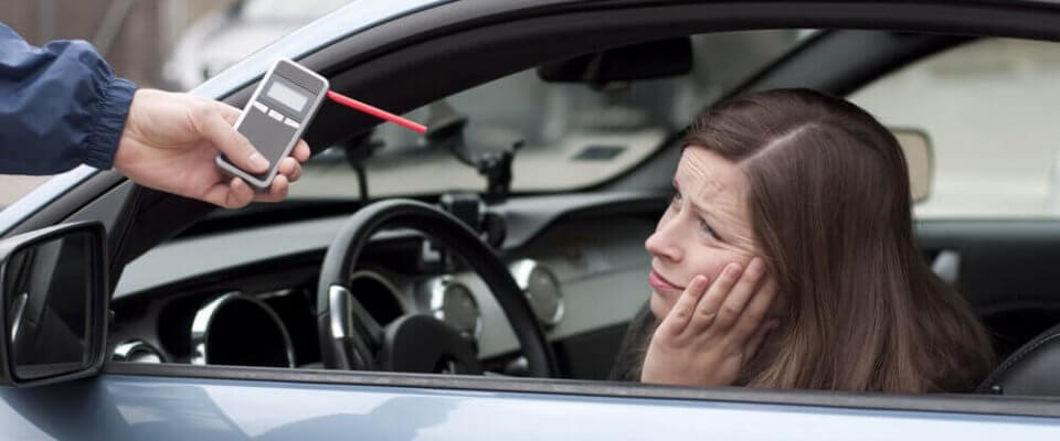 woman inside her car failing a breathilizer test and getting a DUI in california