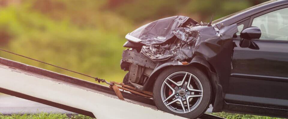 crashed car being towed