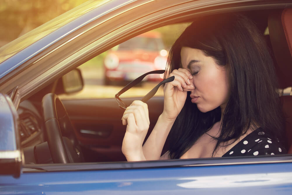 frustrated woman in car after a hit and run accident