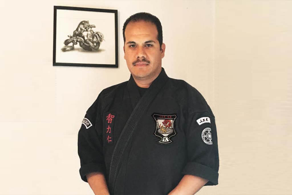 front view of smiling man with martial arts uniform