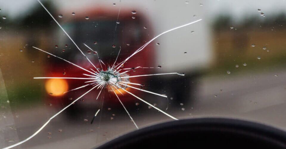 Close up to a cracked windshield that can be repaired thanks to insurance