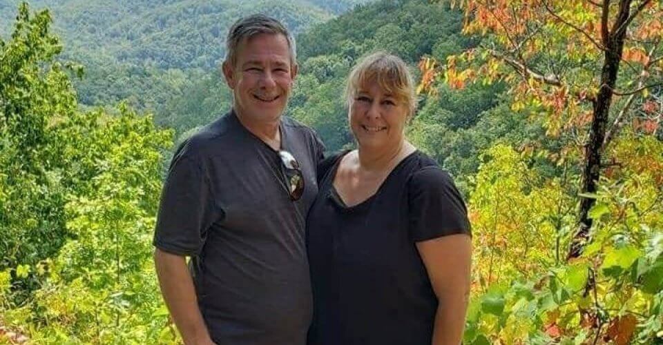 Happy older couple of freeway community heroes with nature as background