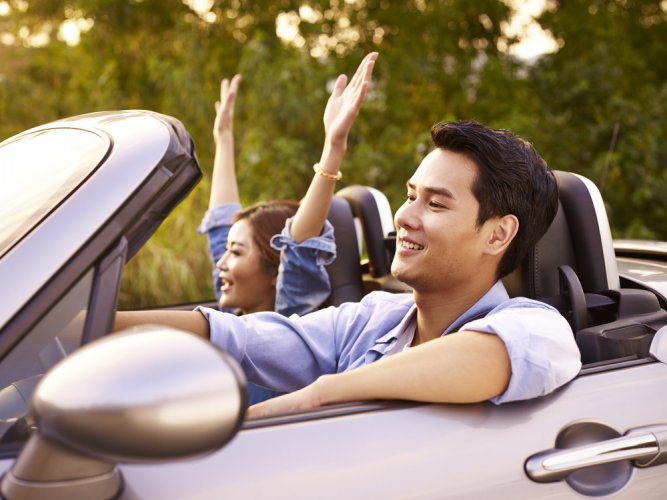 happy asian couple in car