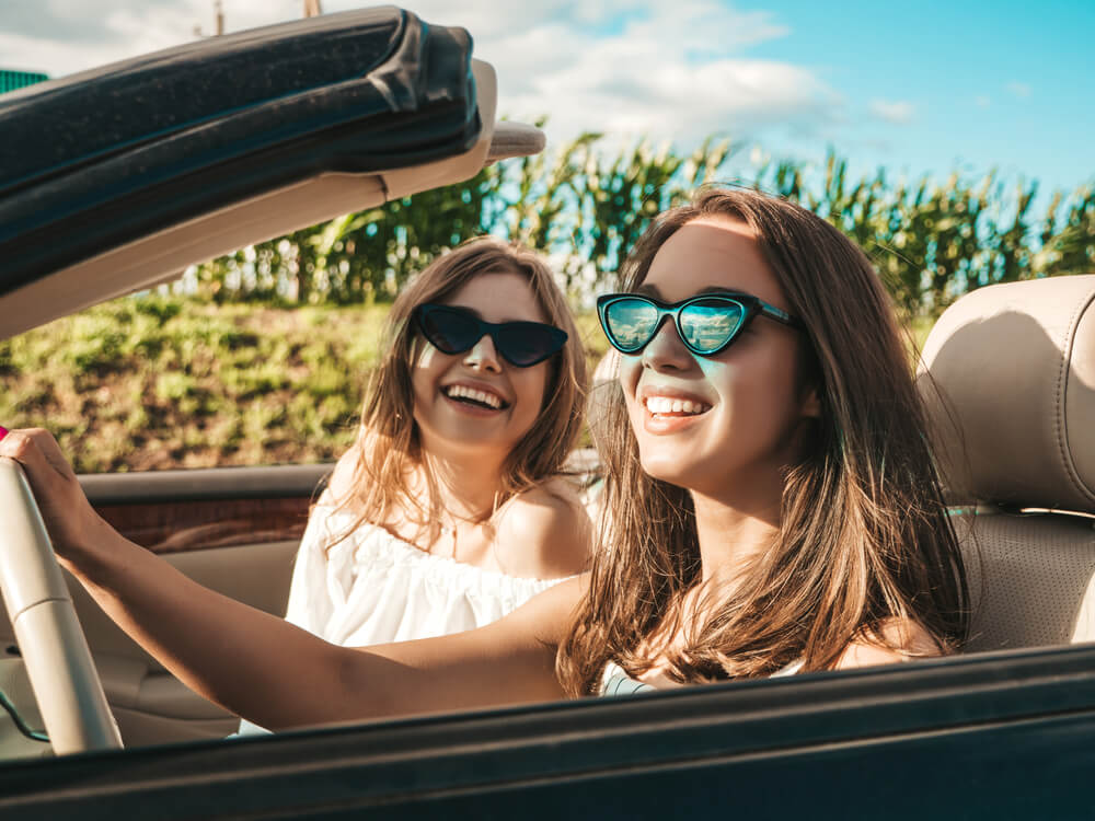 two happy women in convertible car