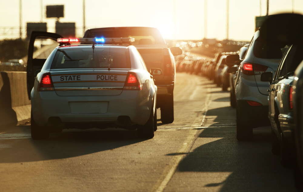 cop car stopping car in freeway for dui