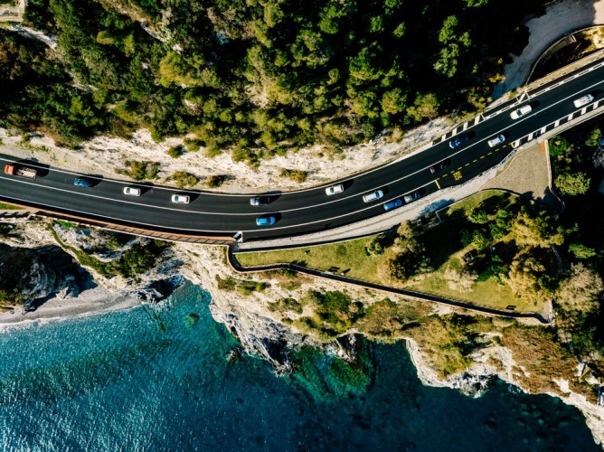 aerial view of highway next to the ocean