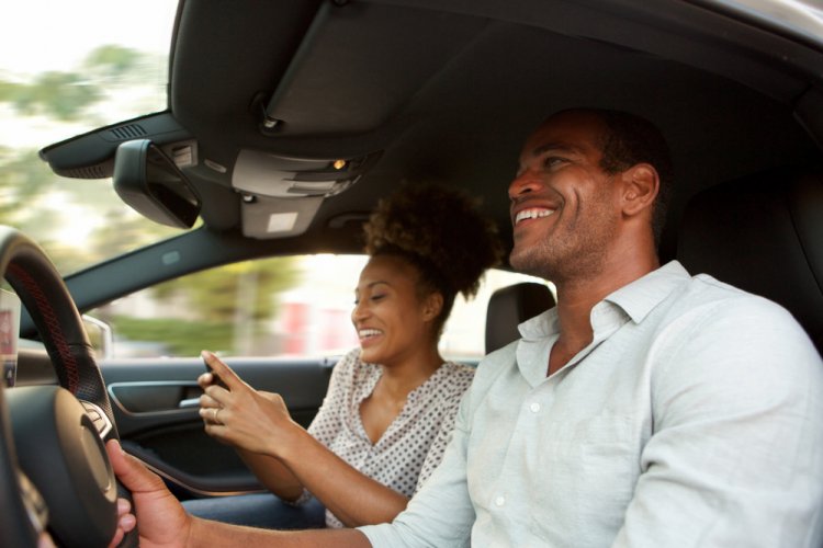 african american couple smiling in the car