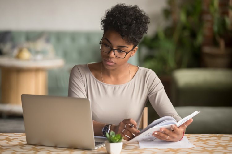 african american woman searching auto insurance on laptop