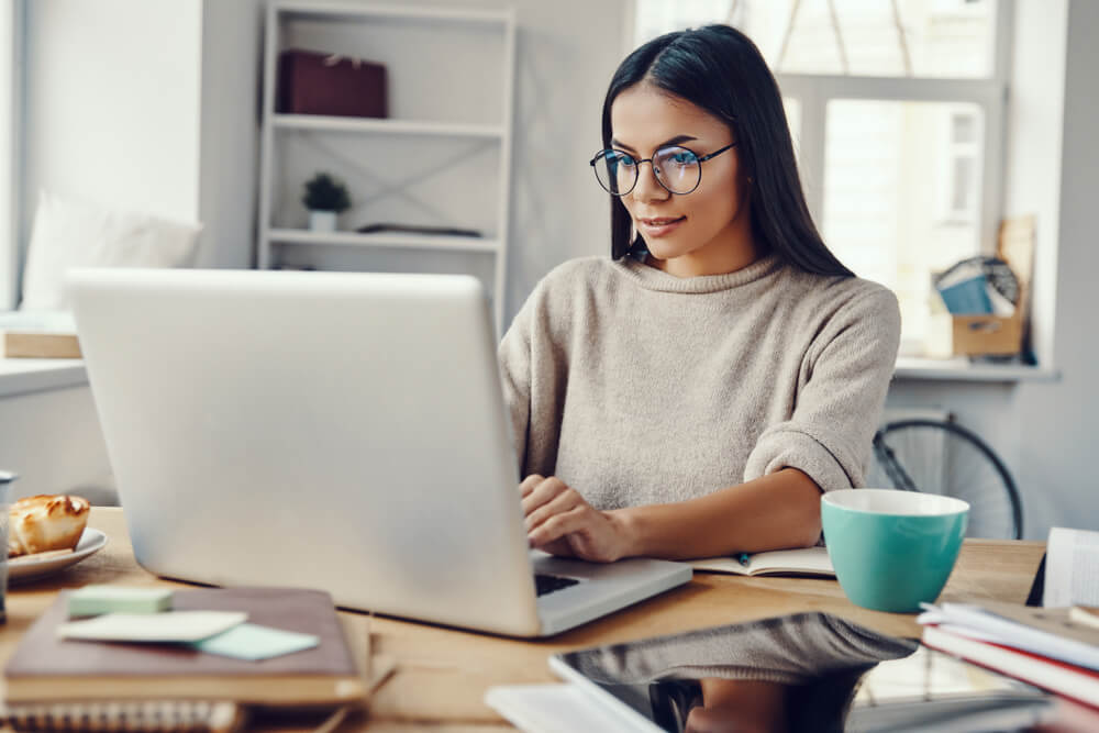woman working from home in front of laptop
