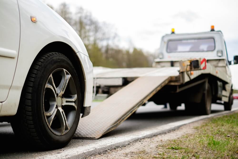 car getting towed by towtruck