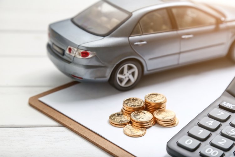 car model,calculator and coins stack on white table