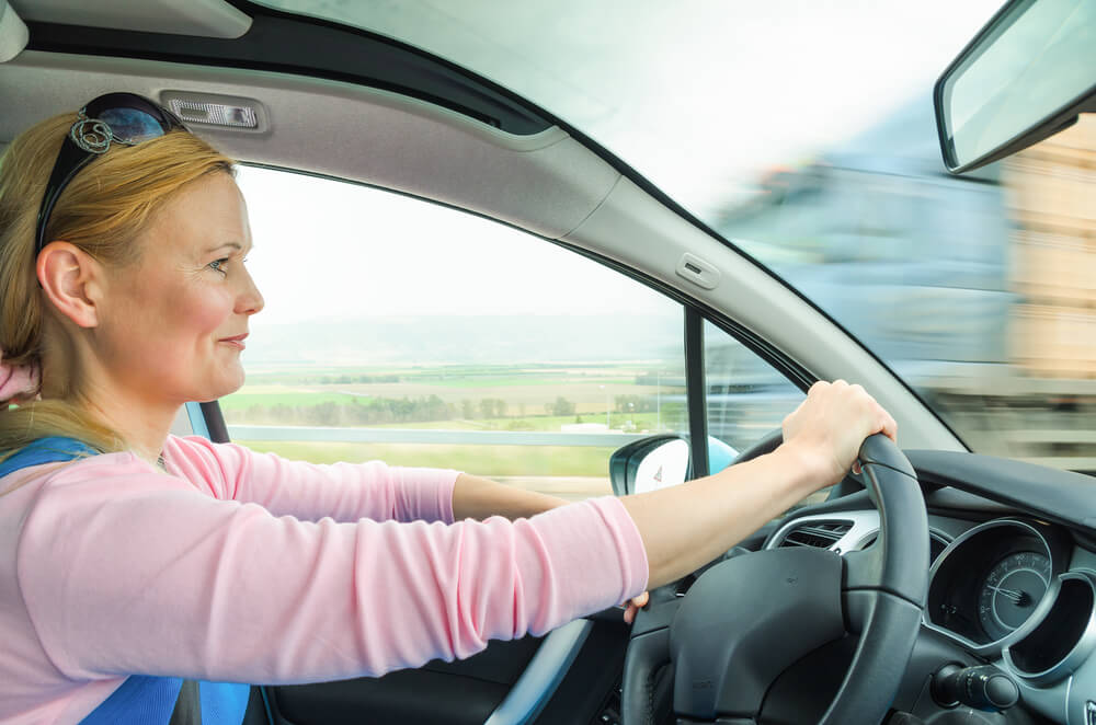 woman defensively driving behind the steering wheel