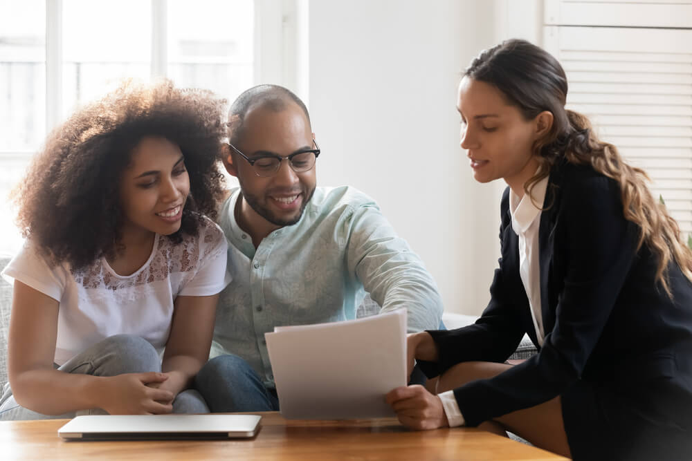 young African American couple reviewing Renters Insurance policy with insurance agent 