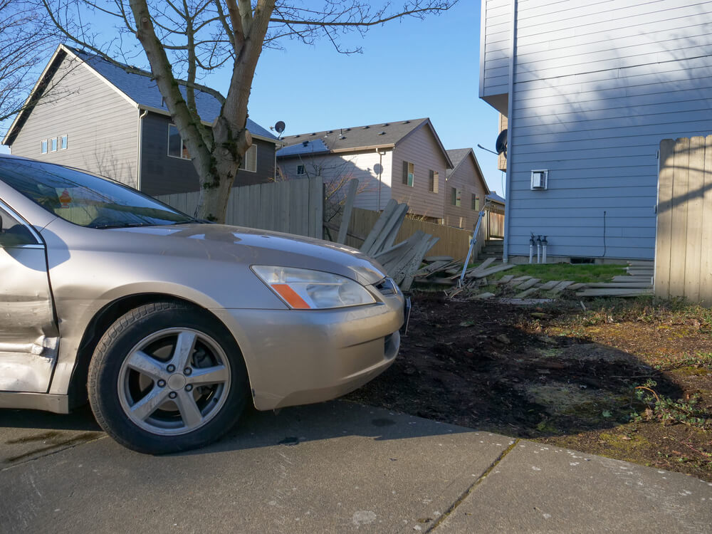 car crashes into fence and destroys fence