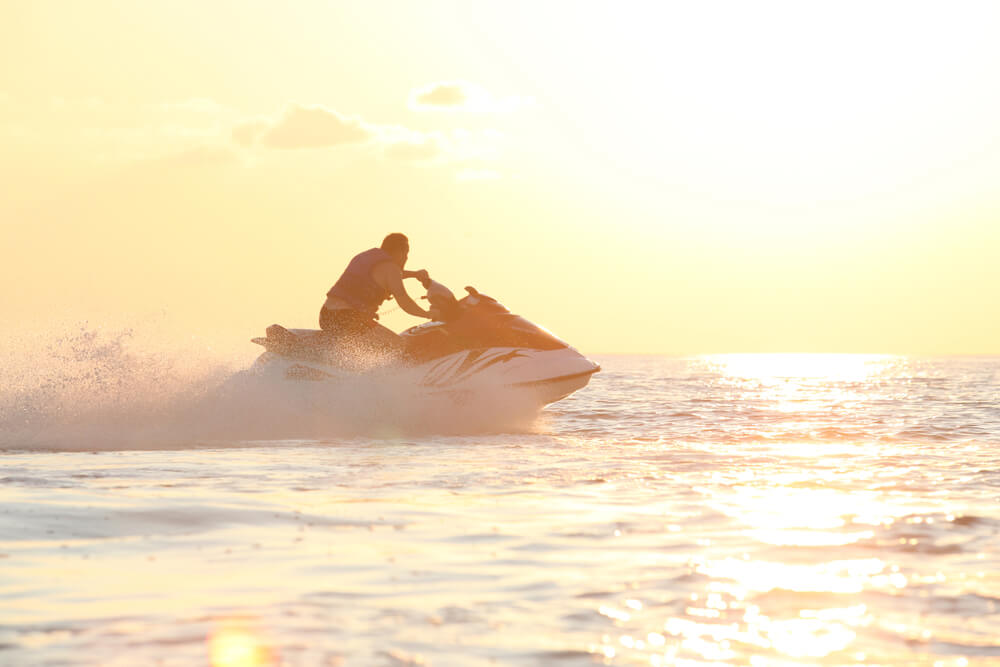 Silhouette of man on jet ski personal watercraft