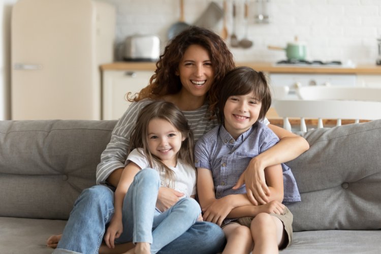 Mom with two children sitting on couch