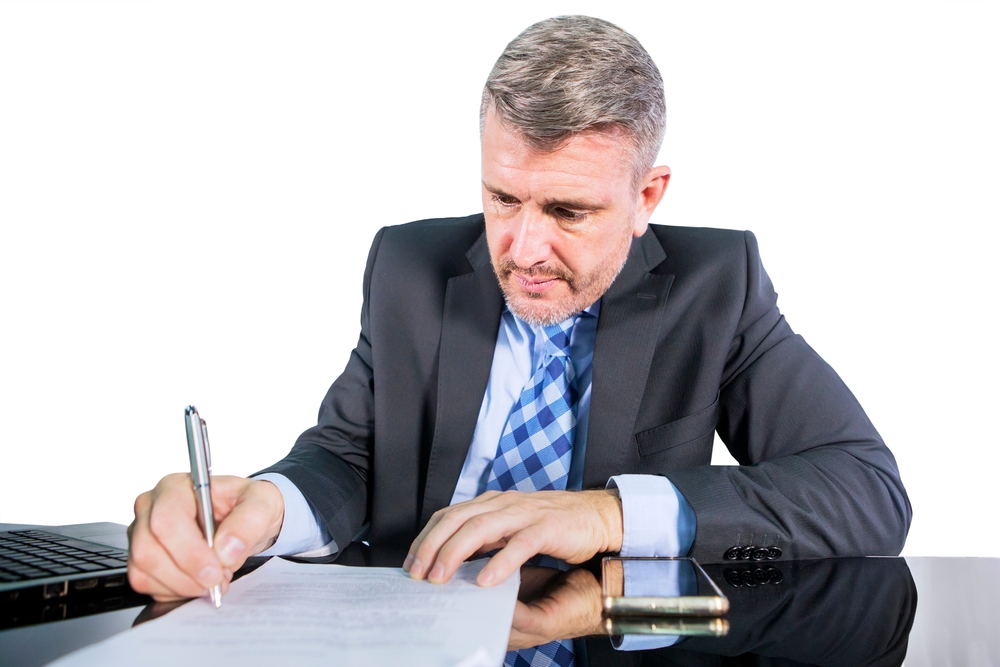 Hispanic man fills out paperwork for his SR22 insurance