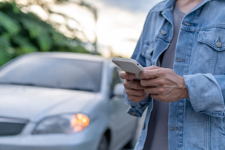 person searching on phone for car insurance