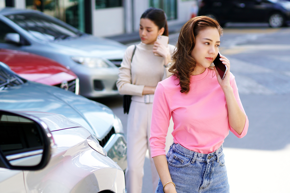 two women on phone after car accident