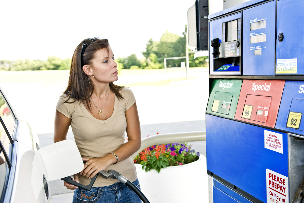 woman filling up gas at gas station