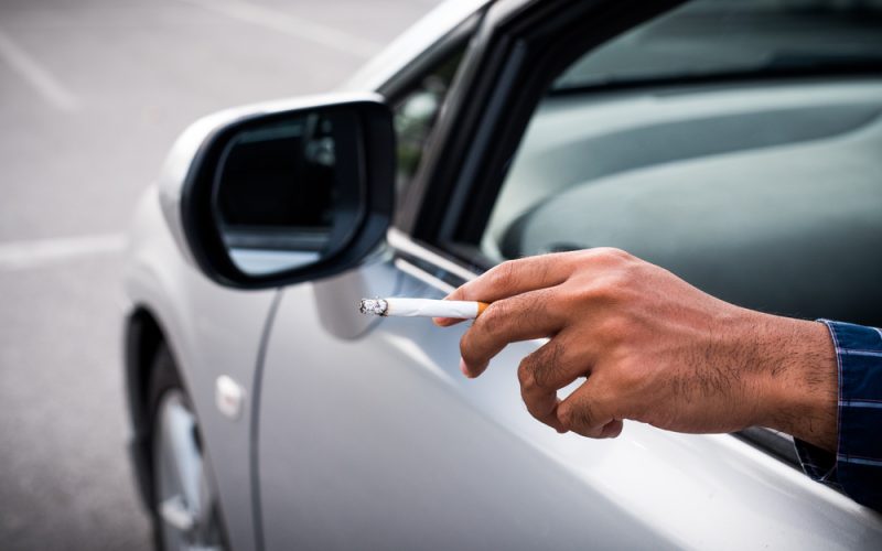 person smoking in car