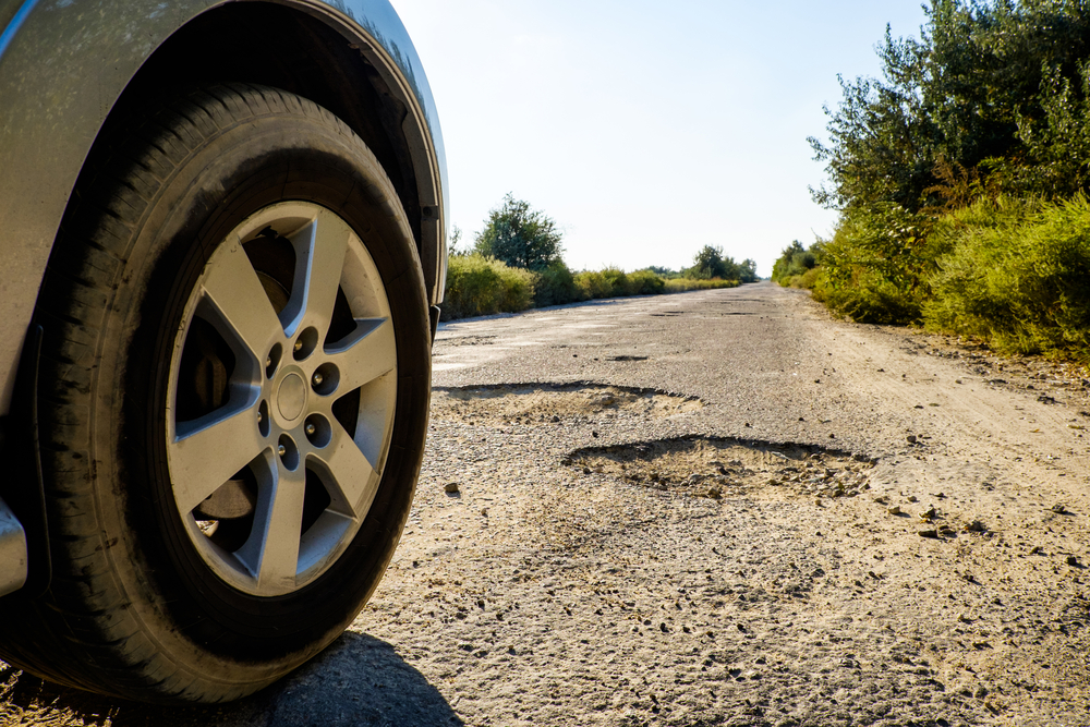 Vehicle facing a pothole on the road