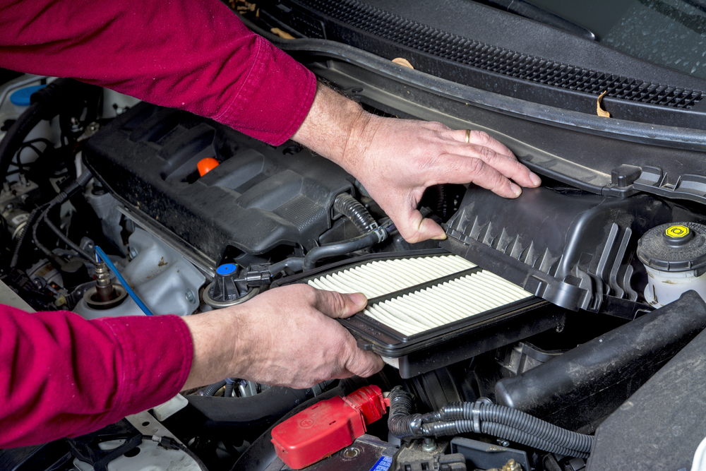 Man replacing the car air filter with a clean one