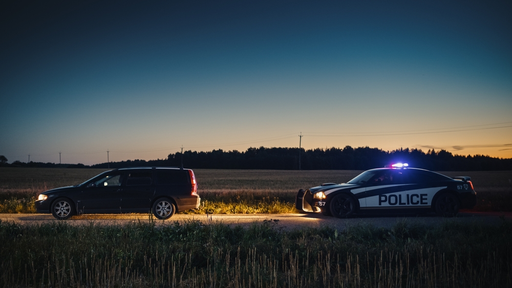 a police car pulls over a driver for a traffic violation