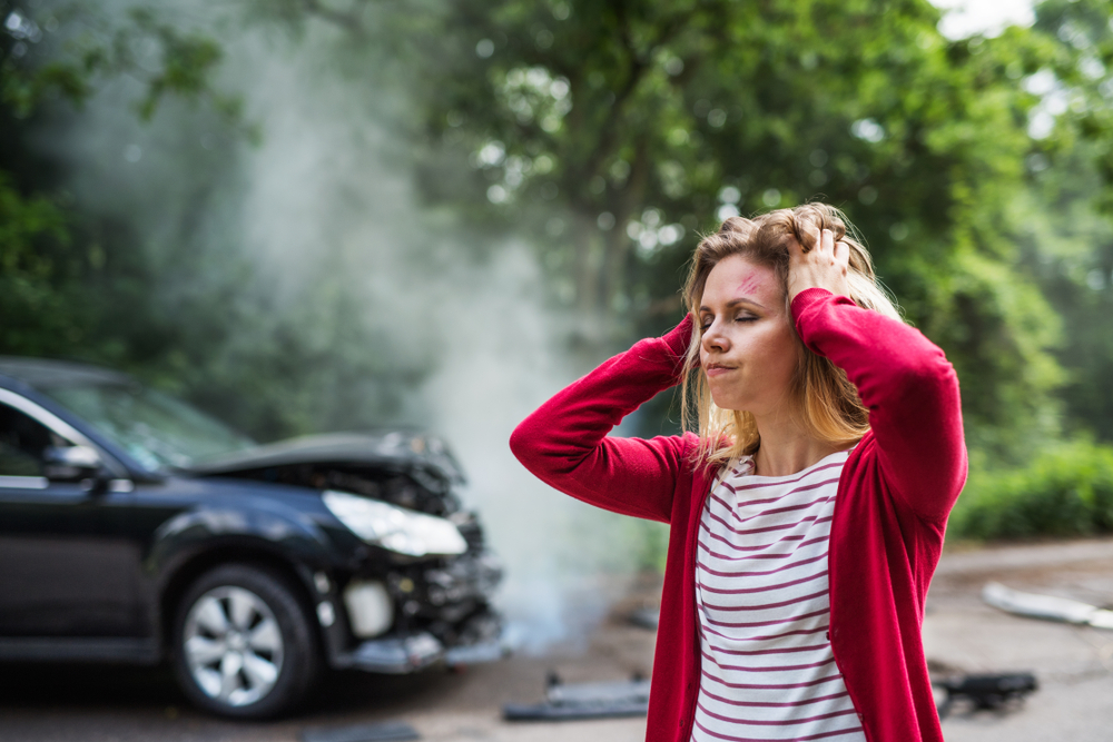 Lady holds head after getting in a car wreck