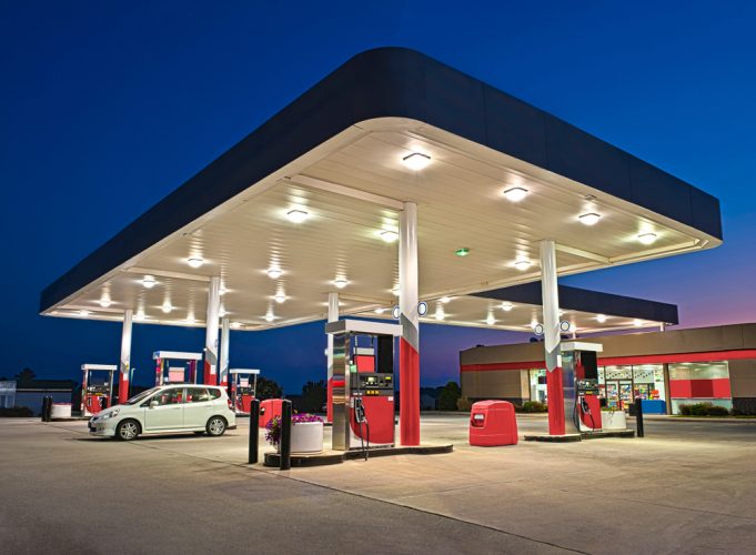 A well-lit gas station at night