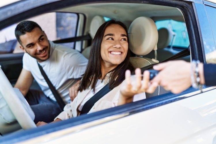 Smiling man and woman in the car.