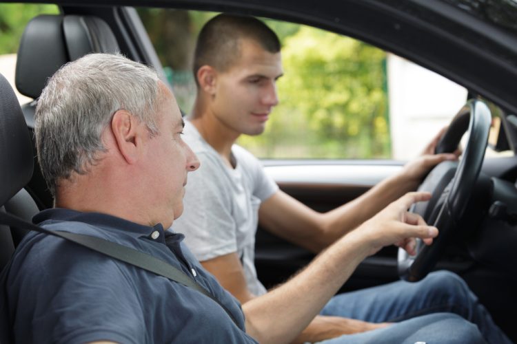 Father teaching son to drive.