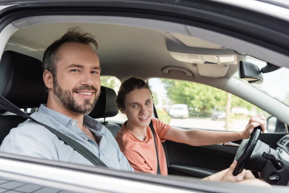 Father teaching daughter how to drive.