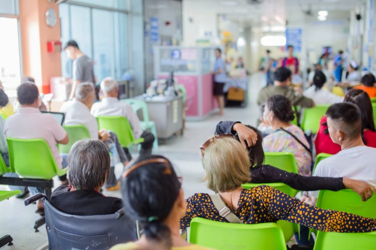 Many patients waiting in an emergency room for healthcare, blurred image - health insurance and urgent care
