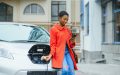 A lady charging her electric vehicle ahead of her travels.