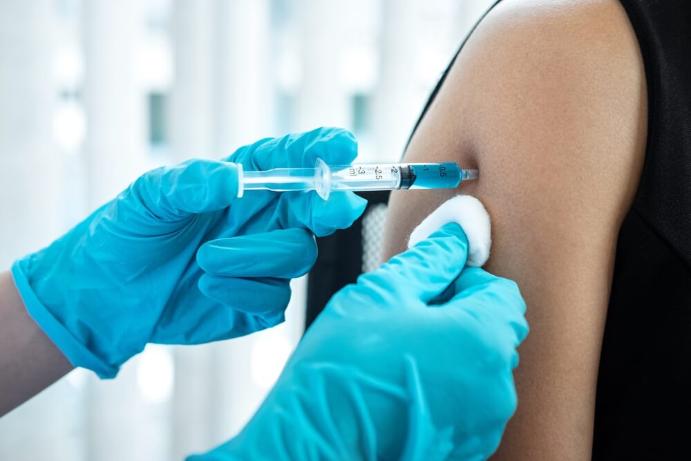 Close-up of a vaccine being administered in the arm, illustrating safe and routine vaccines for disease prevention