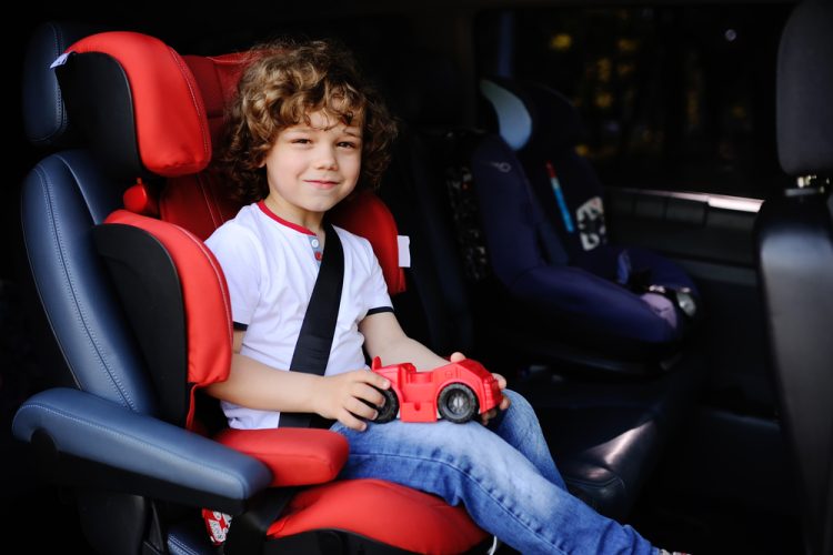 Little boy sitting a car seat