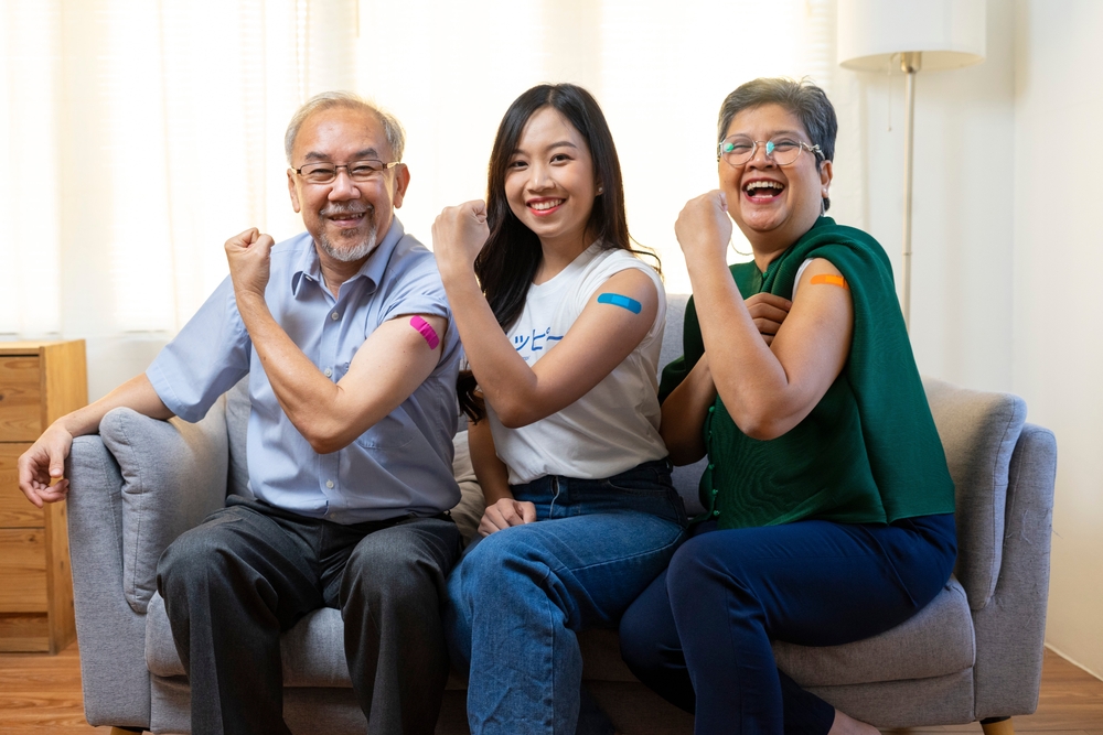 Asian family shows off their vaccinated arms - affordable health insurance
