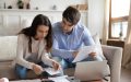 Young couple looks at the pros and cons of low deductible health insurance